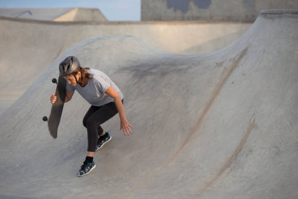 istock Senior woman skateboarding. 860009050