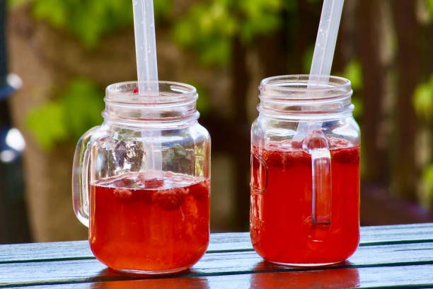 istock Red lemonade glasses with straws 860009318