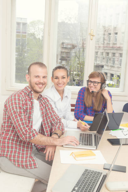 istock Group of young ordinary people working in the office. 860009486