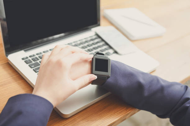 istock Female using smart watch at workplace, close up, side view, 860012722