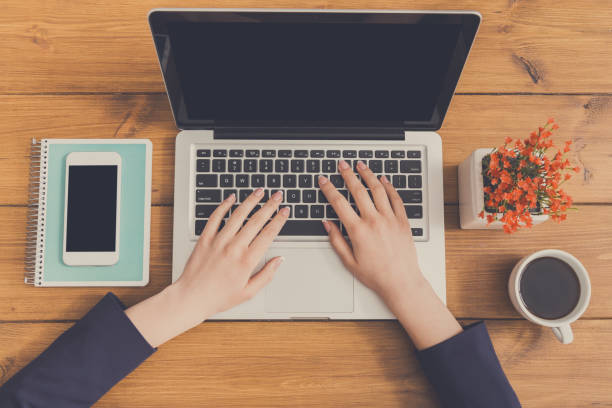 istock Woman using laptop in coffee shop, close-up 860012936