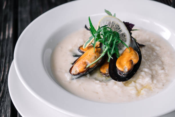 istock Risotto with mussels on dark wood background 860013872