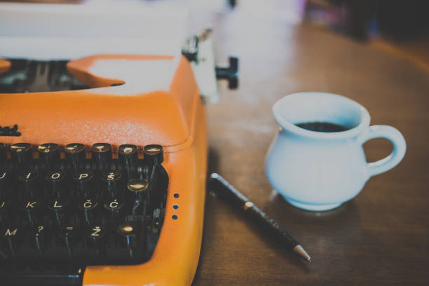istock Vintage orange typewriter and coffee from above 860017214