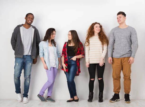 istock Group of diverse students standing in line indoors 860020652