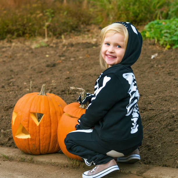 istock smiling child with Halloween pumpkin Jack O