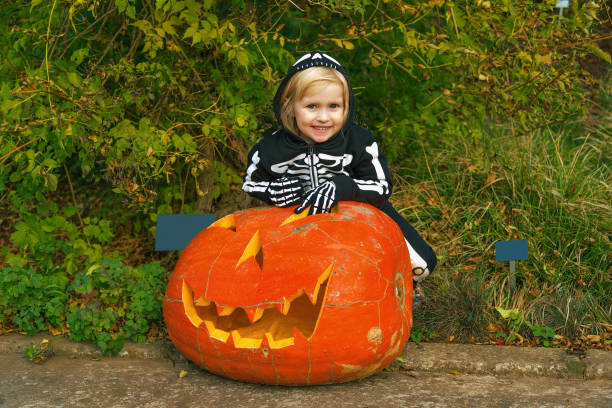 istock happy child with huge Halloween pumpkin Jack O