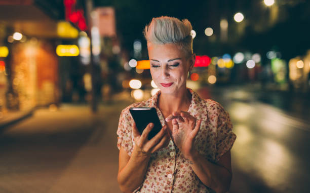 istock Elegant woman texting at night 860021262