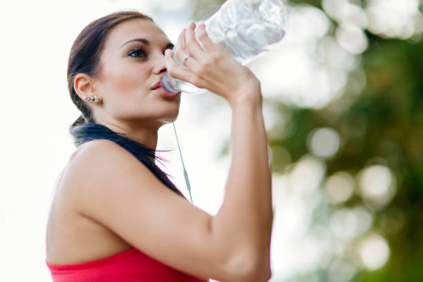 istock Attractive woman drinking water 860024426
