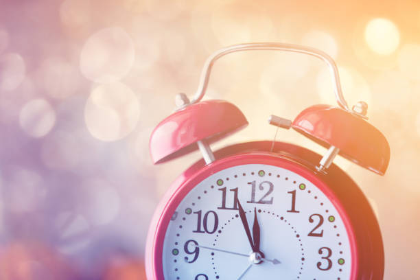 istock Vintage Alarm clock with Christmas gift and Ligths on background 860025090