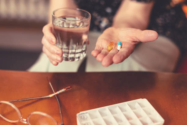 istock Senior woman taking pills 860026256