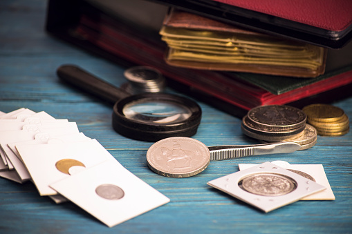 Old silver coin on a wooden background