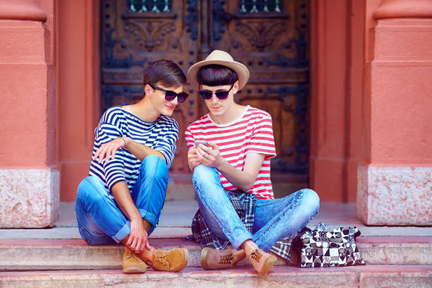 istock young male couple chatting through the mobile device 860032302