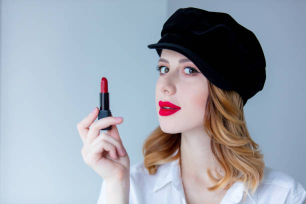 istock Young redhead woman in hat with lipstick for makeup 860032526