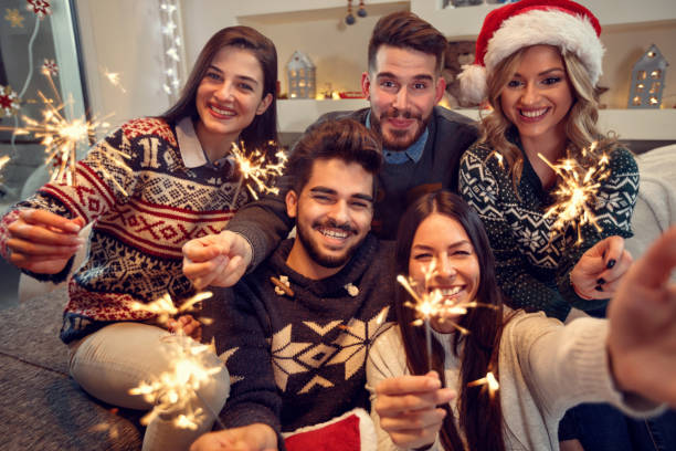 istock friends celebrating Christmas with sparklers 860032688