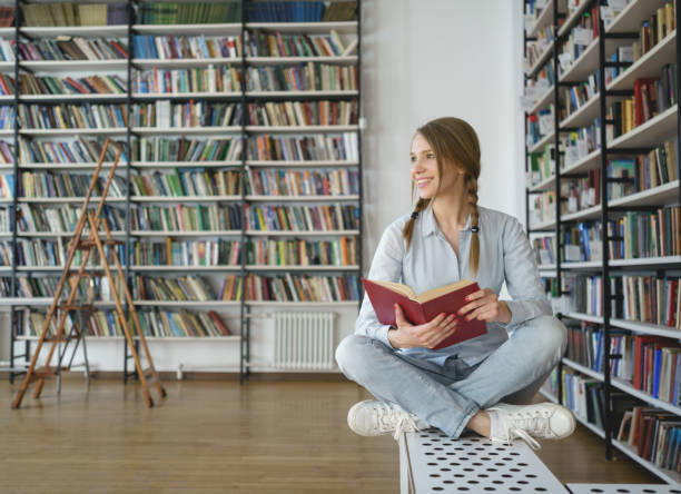 istock Young girl in library 860032800