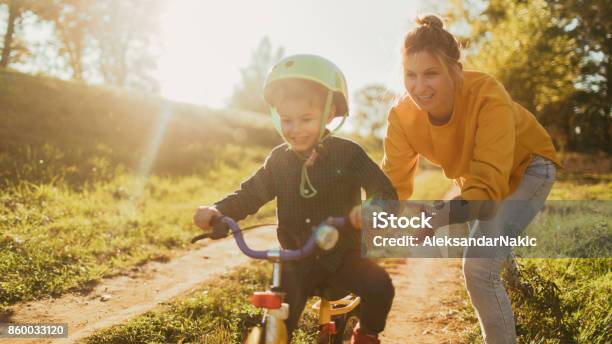 Learning To Ride A Bicycle Stock Photo - Download Image Now - Family, Cycling, Child