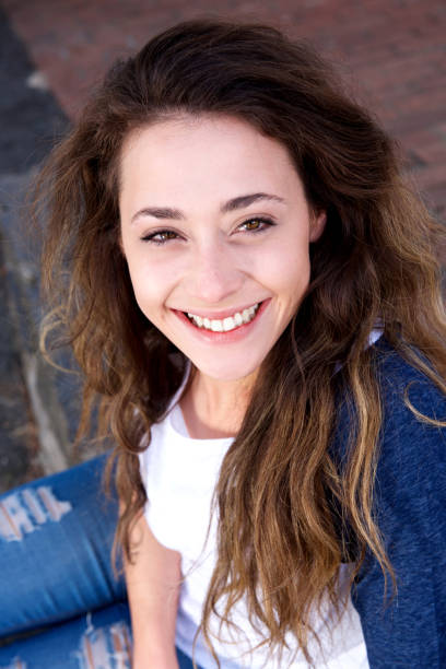 istock happy young woman sitting and looking up 860033132