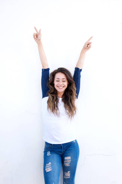 istock happy young woman with arms raised up 860033304