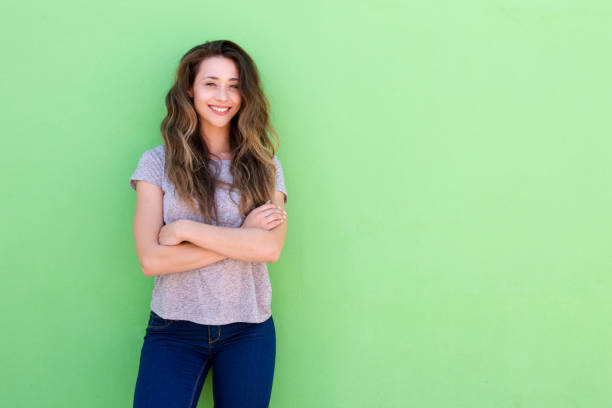 istock happy young woman standing with folded arms 860035554