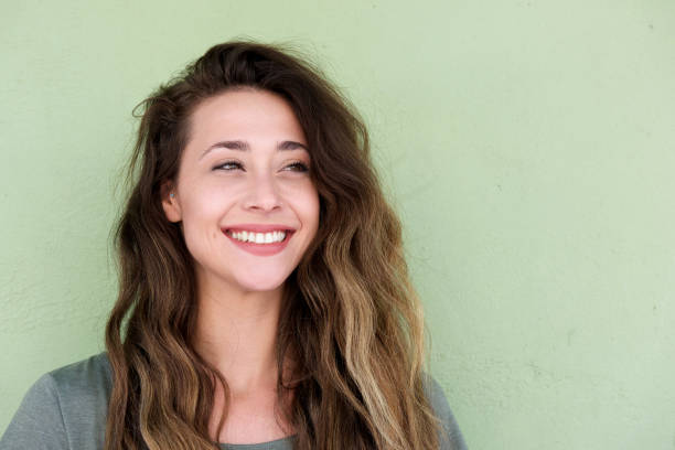 young beautiful woman on green background smiling stock photo