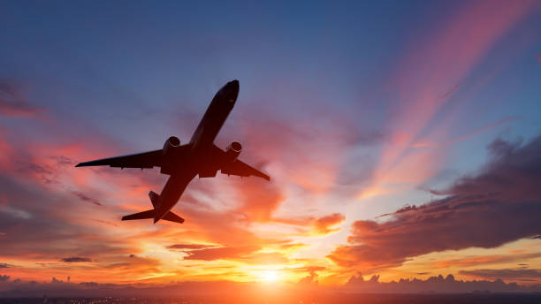 istock The silhouette of a passenger plane flying in sunset. 860035730