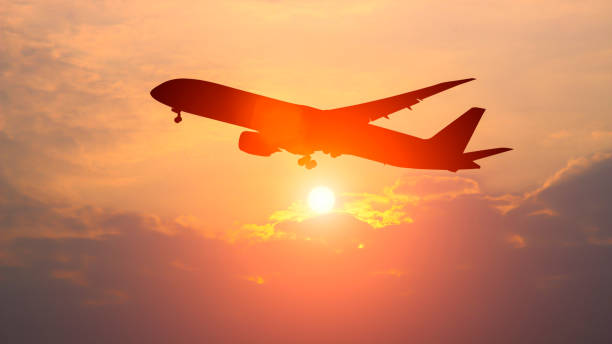 istock The silhouette of a passenger plane flying in sunset. 860035738