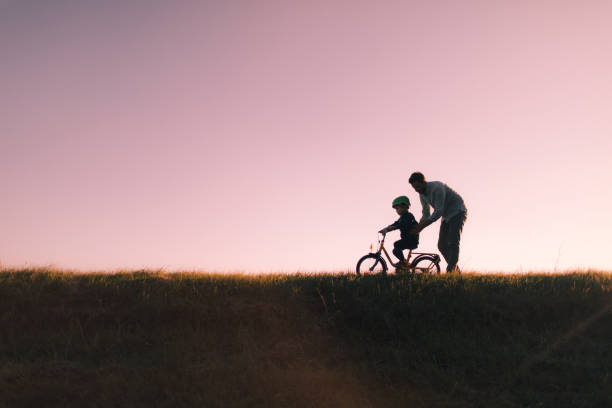 istock Father and son on a bicycle lane 860036072