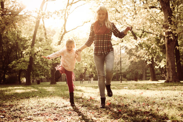 istock Mother and daughter playing together in forest. 860036426