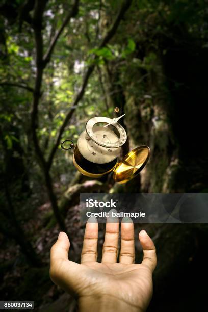 Surrealistic Disintegrate Compass Floating Over Hand Stock Photo - Download Image Now