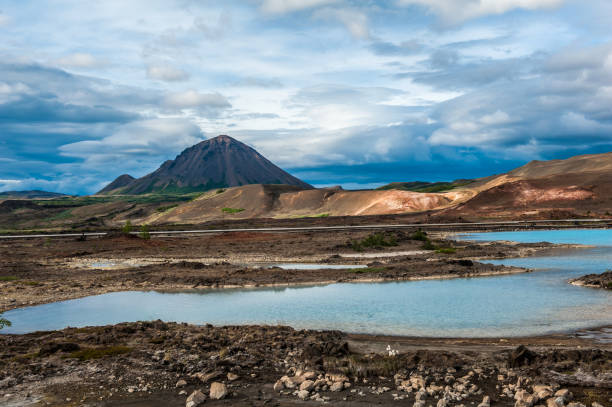 Volcanic landscape of Iceland Turquoise hot pools and a mighty volcano at Namafjall, Myvatn area - Iceland sulphur landscape fumarole heat stock pictures, royalty-free photos & images