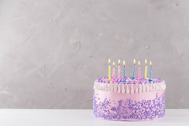 istock Birthday cake with colorful candles over gray background 860040702