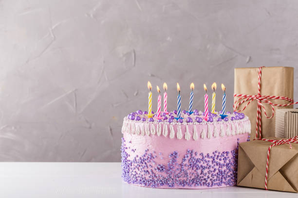 istock Birthday cake with colorful candles over gray background 860040706