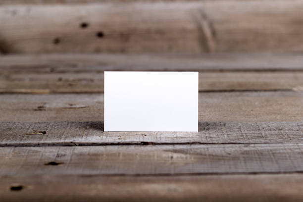 istock Business cards isolated on old wood background 860044292