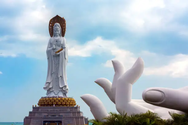 Buddhist goddess and stone hand duplicating the statue.