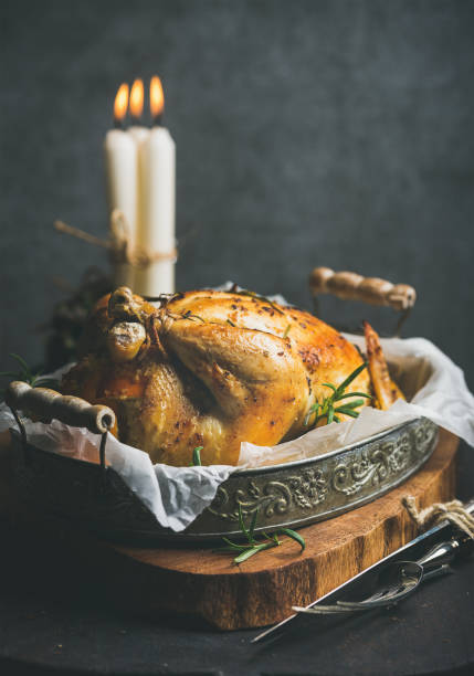 istock Christmas holiday table set with roasted whole chicken and candles 860048534