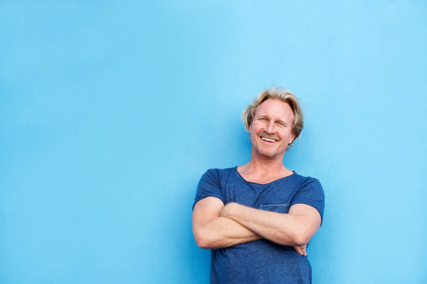 istock smiling middle aged man posing with arms crossed 860048824