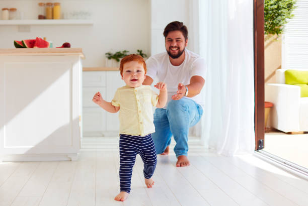 istock cute little baby boy making his first steps at home 860056088
