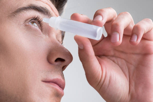 istock Attractive guy is using medical product for eyeball 860063920