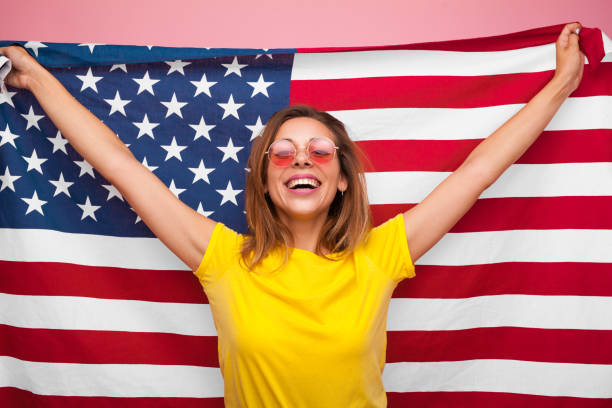 istock Laughing woman with flag on pink 860064346