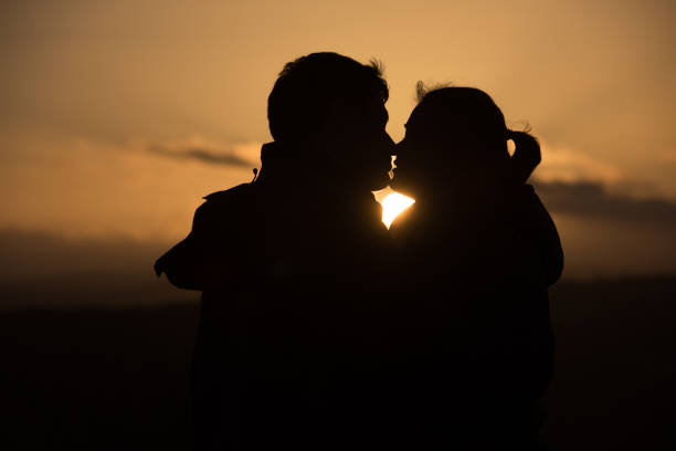 istock young couple in front of sunset 860065148