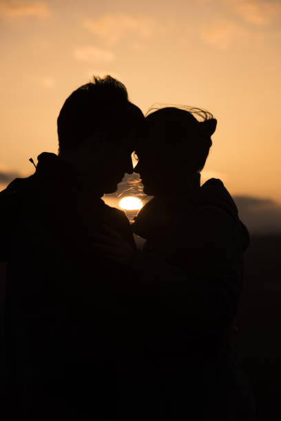 istock young couple in front of sunset 860065156