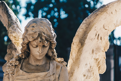 Close up of a sculpture stone carved in the old Monumentale Cemetery in Milan