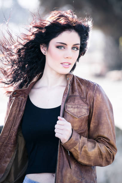 istock Brunette model posing outside in an industrial setting 860069626