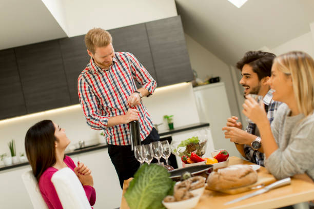 istock Group of young people drinking wine in the room 860073262