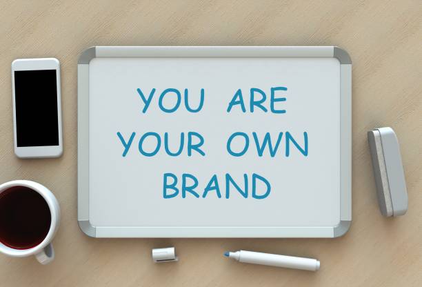 istock You Are Your Own Brand, message on whiteboard, smart phone and coffee on table, 3D rendering 860075718