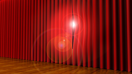 light peeping through theatre curtains on stage.