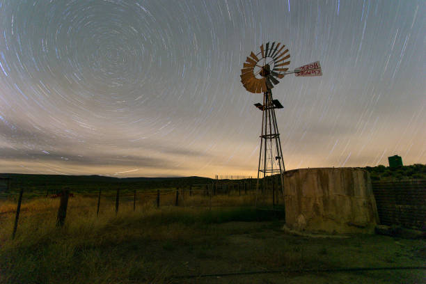 istock Windpomp/Windmill with the milky way in the sky 860075994