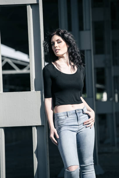 istock Brunette model posing outside in an industrial setting 860076450