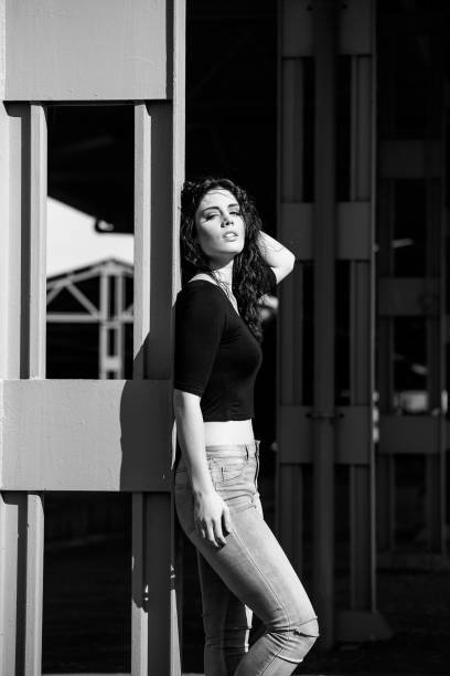 istock Brunette model posing outside in an industrial setting 860076454