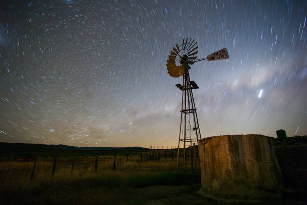 istock Windpomp/Windmill with the milky way in the sky 860076770